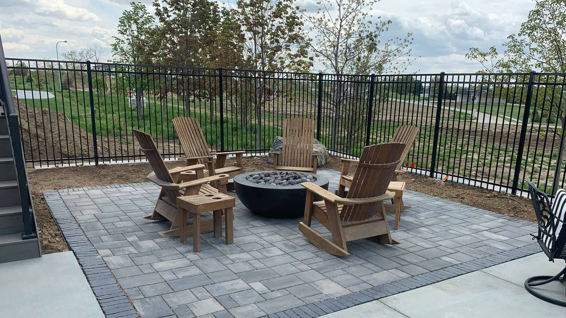 Fire pit and patio hardscape installed for backyard in Omaha, NE.