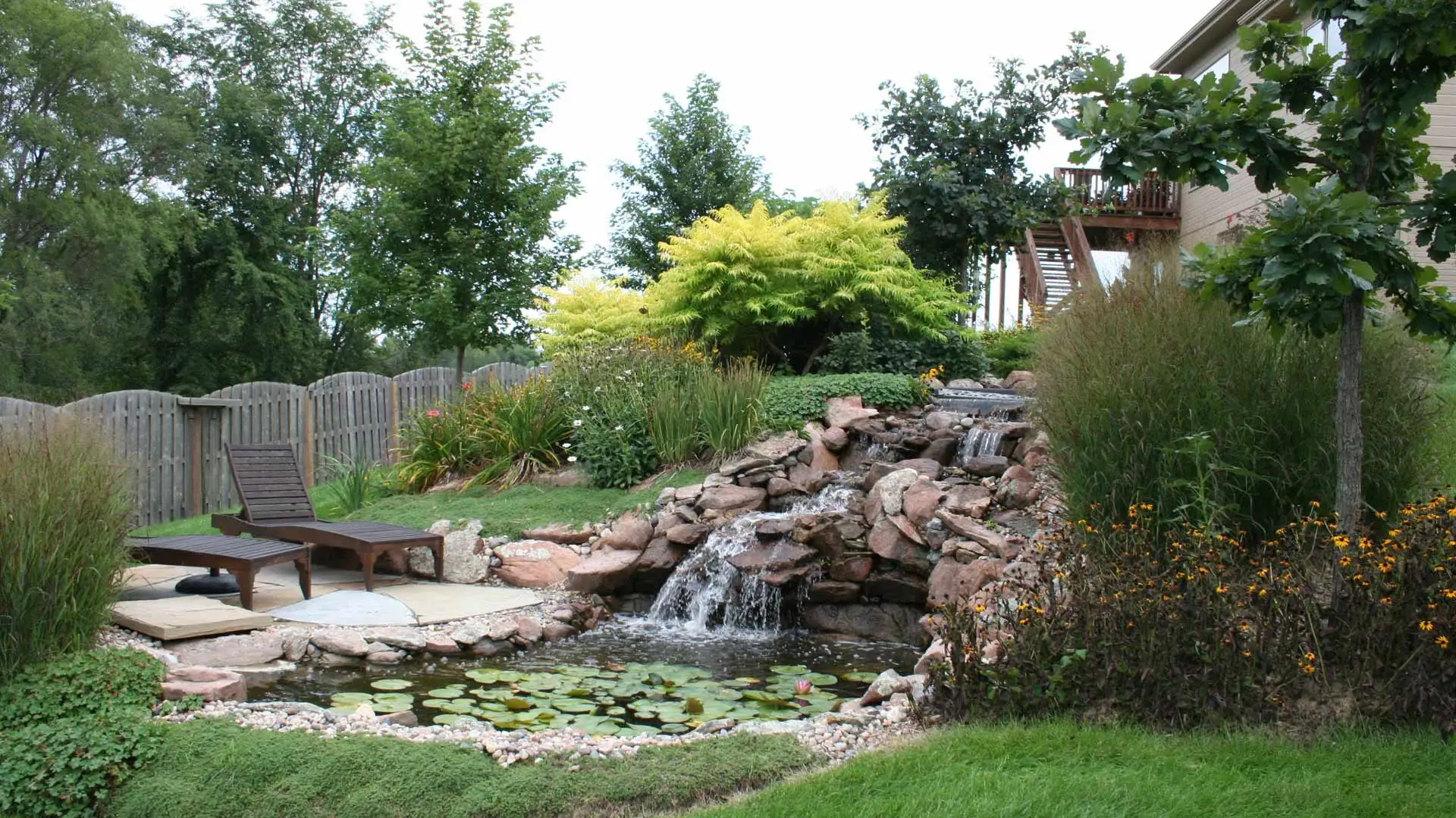 Waterfall with pond installed for backyard in Millard, NE.