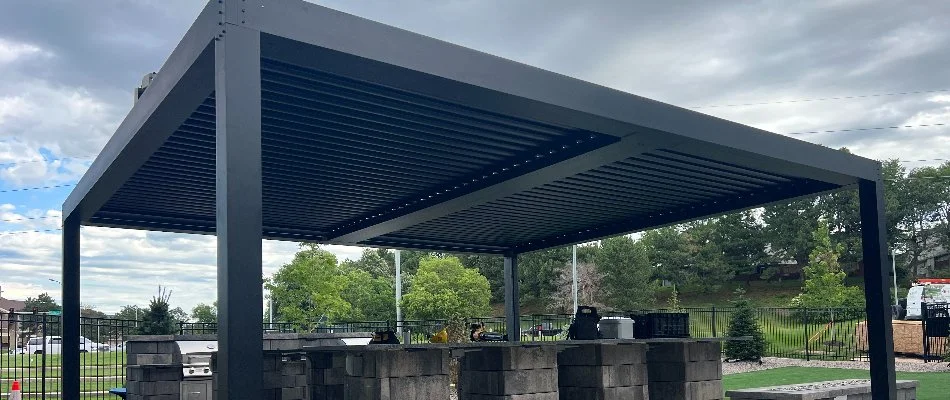 Black metal pergola over a kitchen area in Omaha, NE.