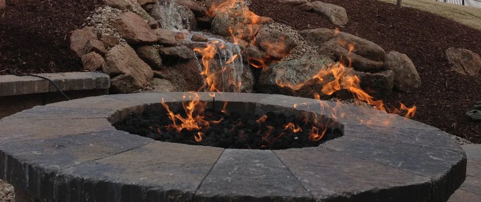 Close-up of a fire pit in Omaha, NE, with flames.