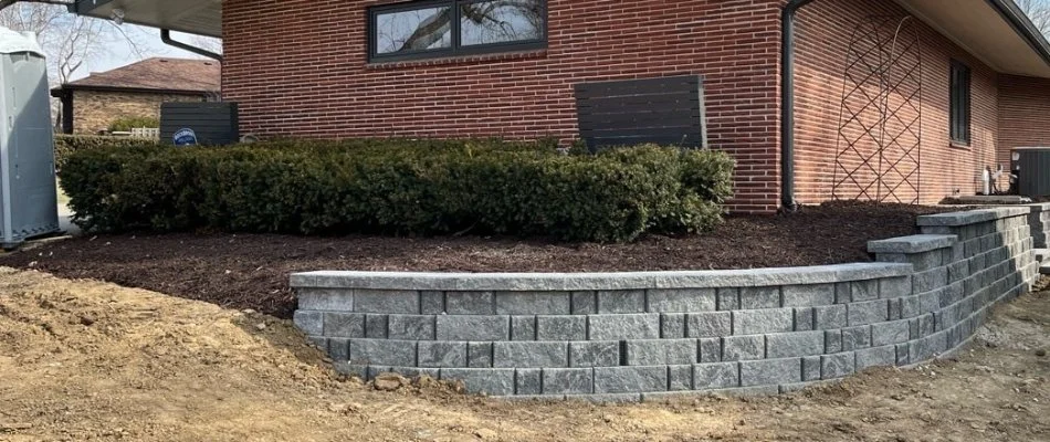 Landscape bed in Omaha, NE, on a retaining wall.