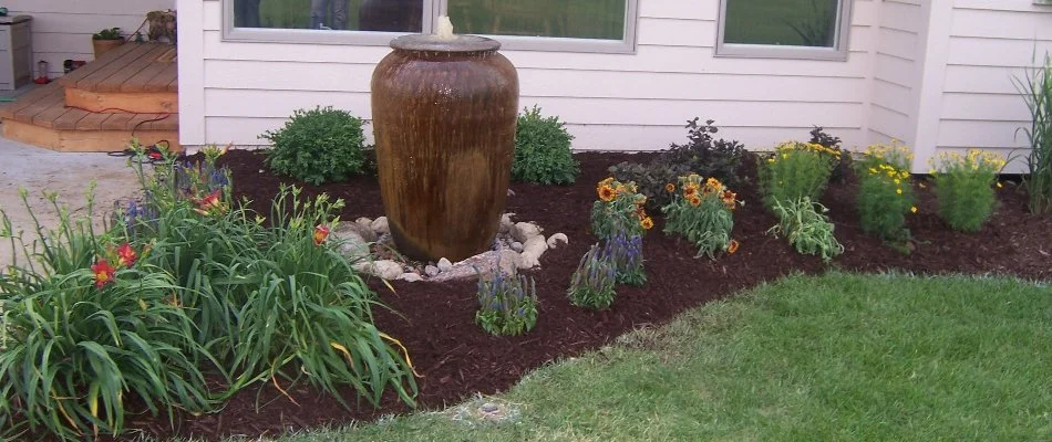 Landscape bed in Omaha, NE, with flowers.