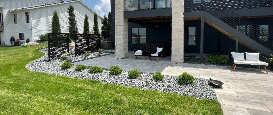 Landscape with rocks in Omaha, NE, around a patio.