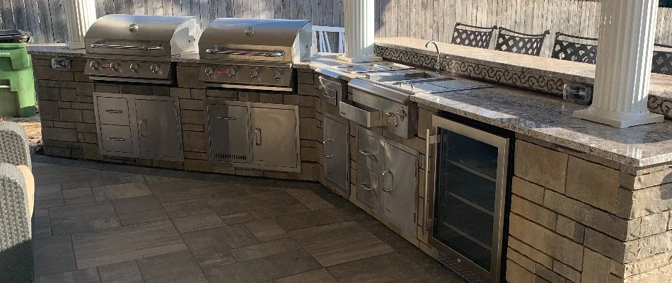 Outdoor kitchen in Omaha, NE, with sink and two grills.