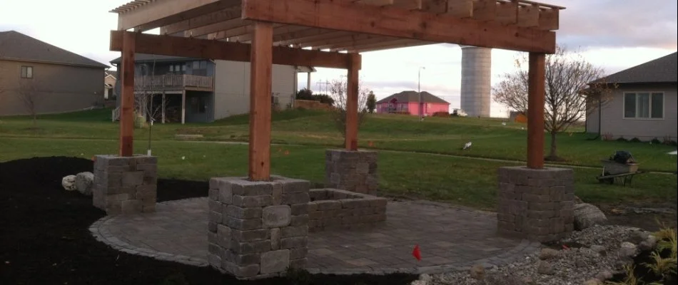 Patio in Omaha, NE, with fire pit and pergola.