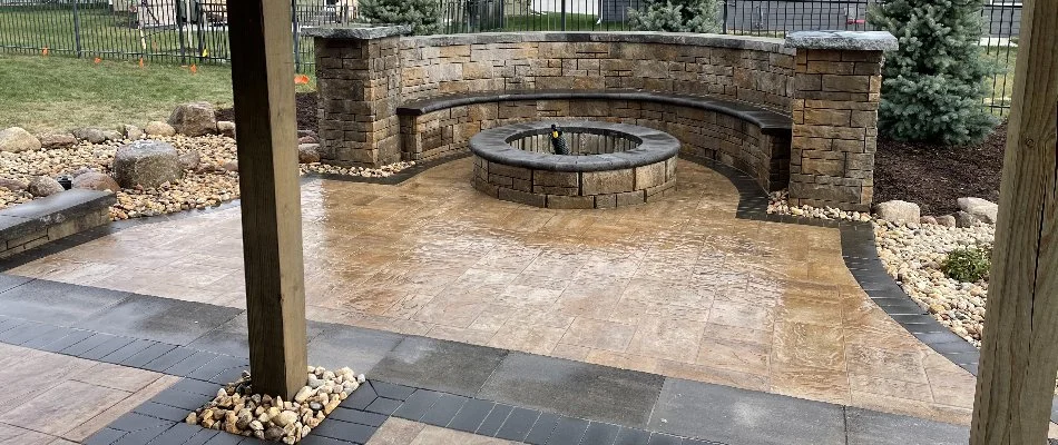 Patio in Omaha, NE, with a fire pit and seating wall.