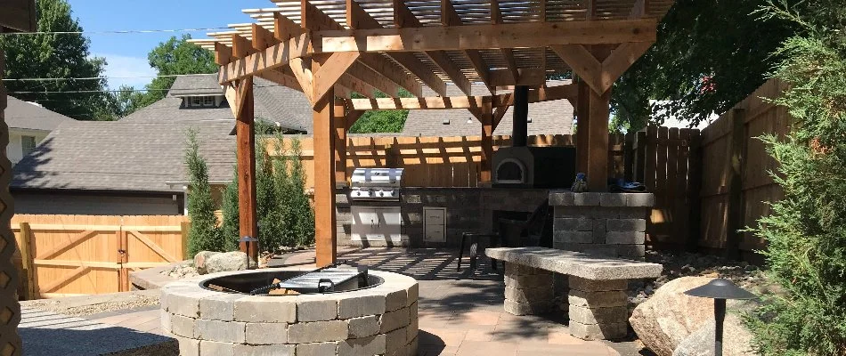 Pergola, outdoor kitchen, and fire pit in Omaha, NE.