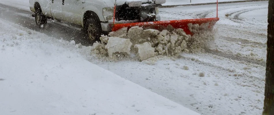 Plow truck clearing snow from a road in Omaha, NE.
