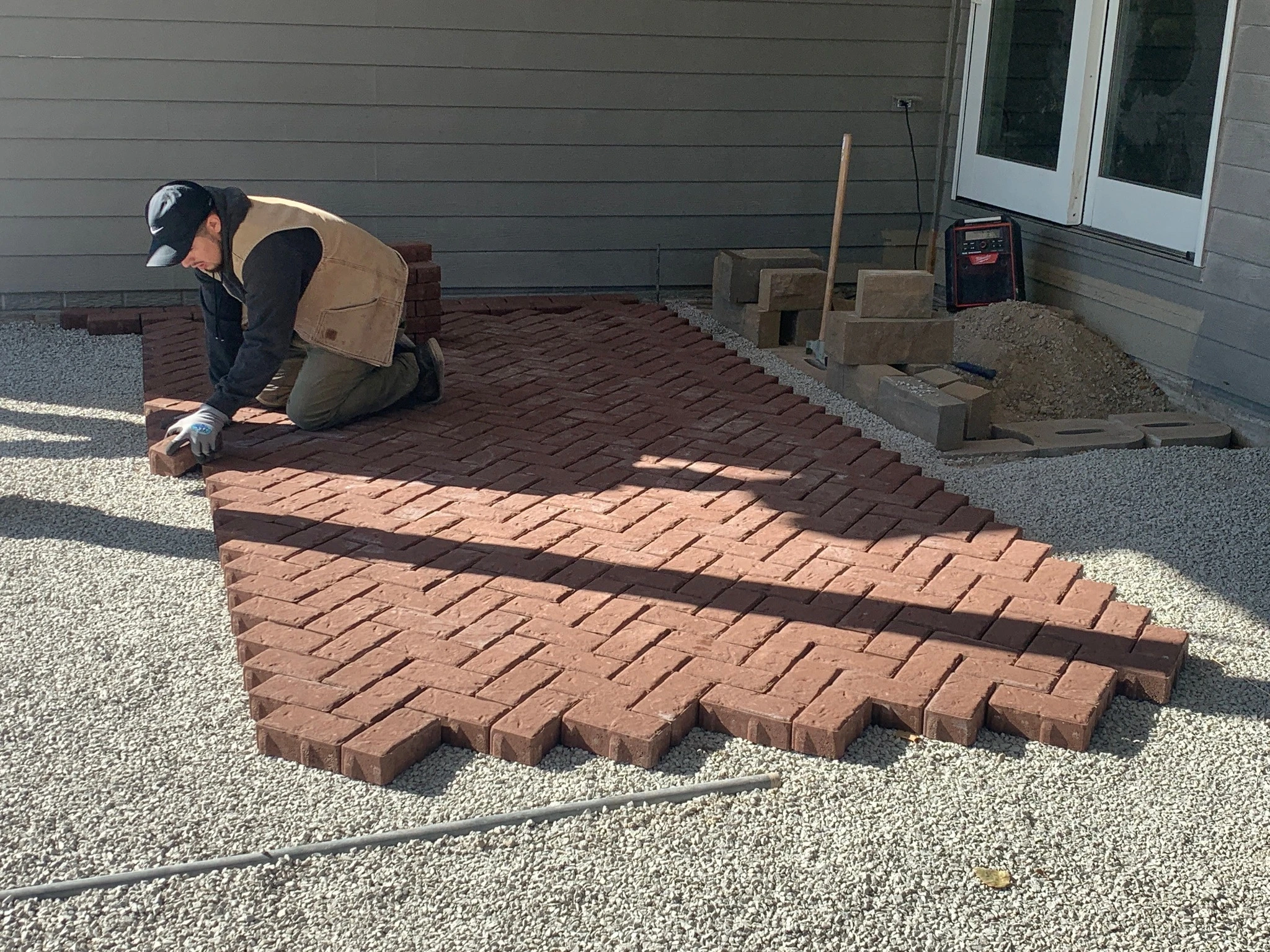 Professional laying pavers for patio build.