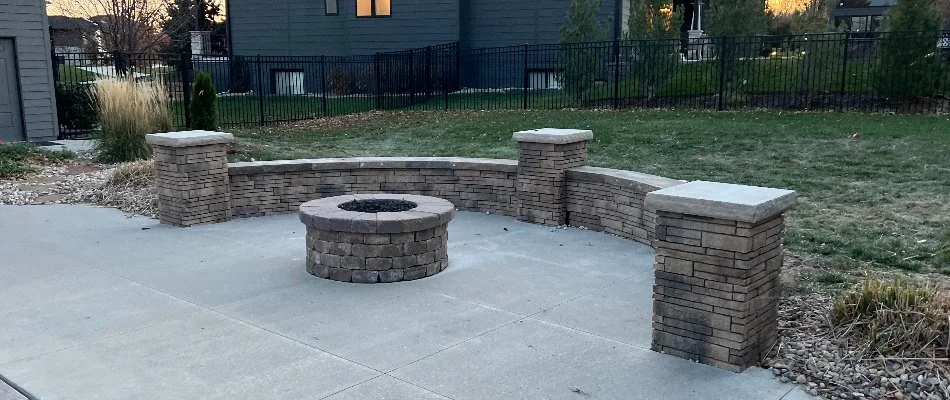 Fire pit in Omaha, NE, with a seating wall.