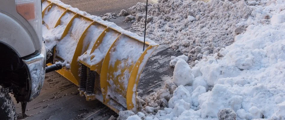 Snowy, icy road in Omaha, NE, being plowed.