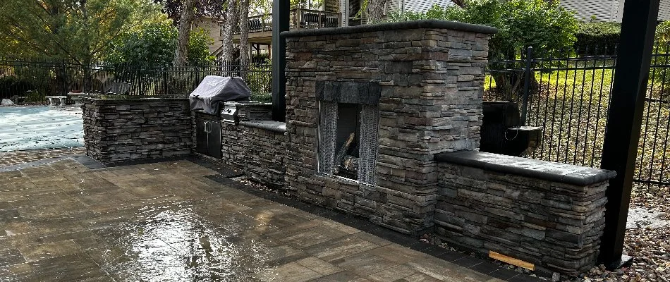 Stone outdoor fireplace on a patio in Omaha, NE.