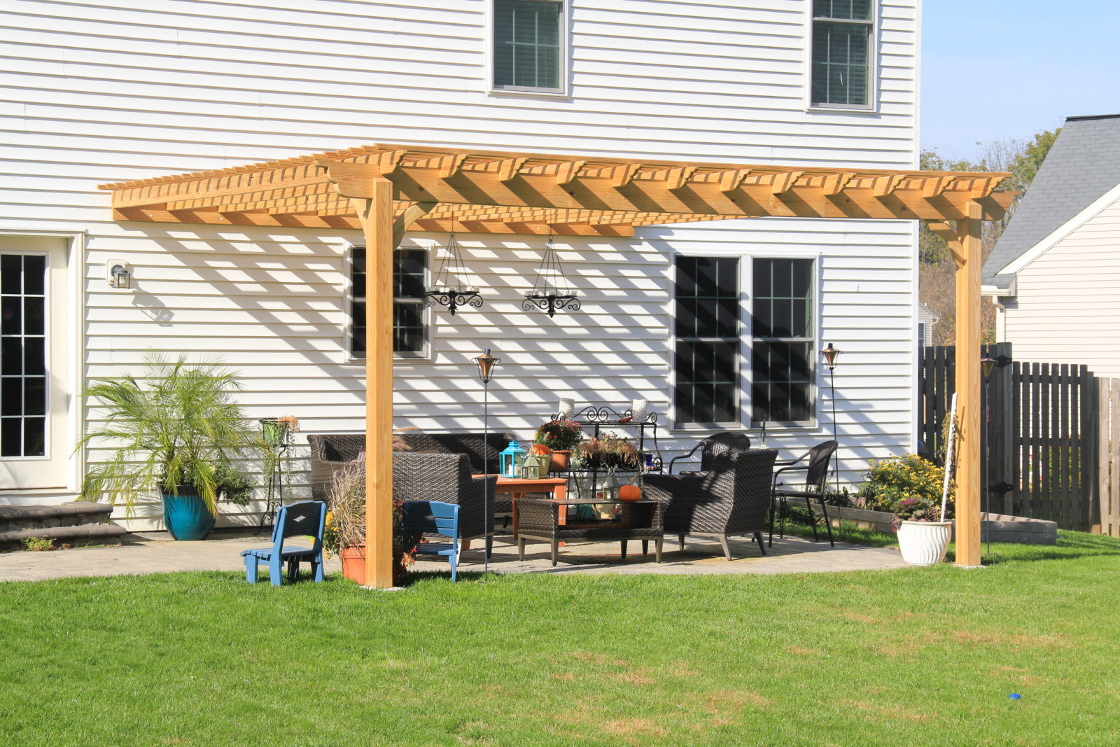 Wooden pergola attached to existing structure
