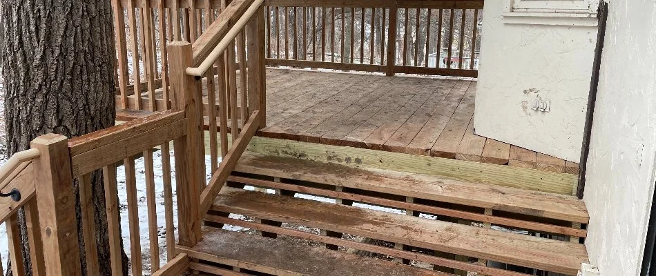 Wooden deck near a tree trunk in Omaha, NE.