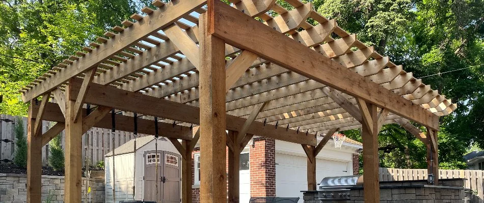 Wooden pergola over an outdoor space in Omaha, NE.