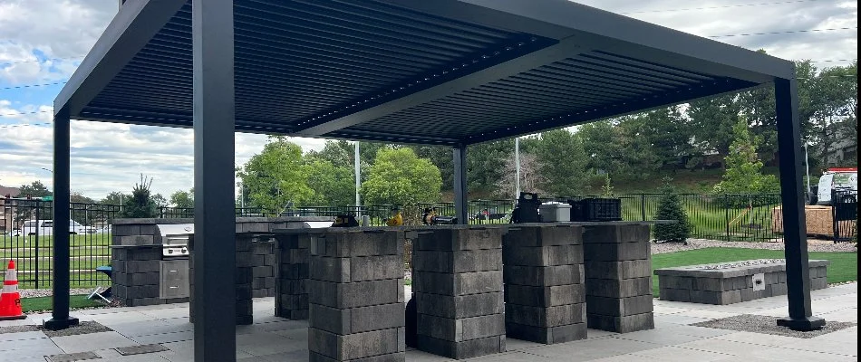 Black pavilion in Omaha, NE, with an outdoor kitchen under. 