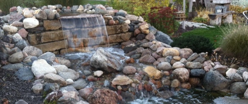 Waterfall feature installed over landscape in Valley, NE.