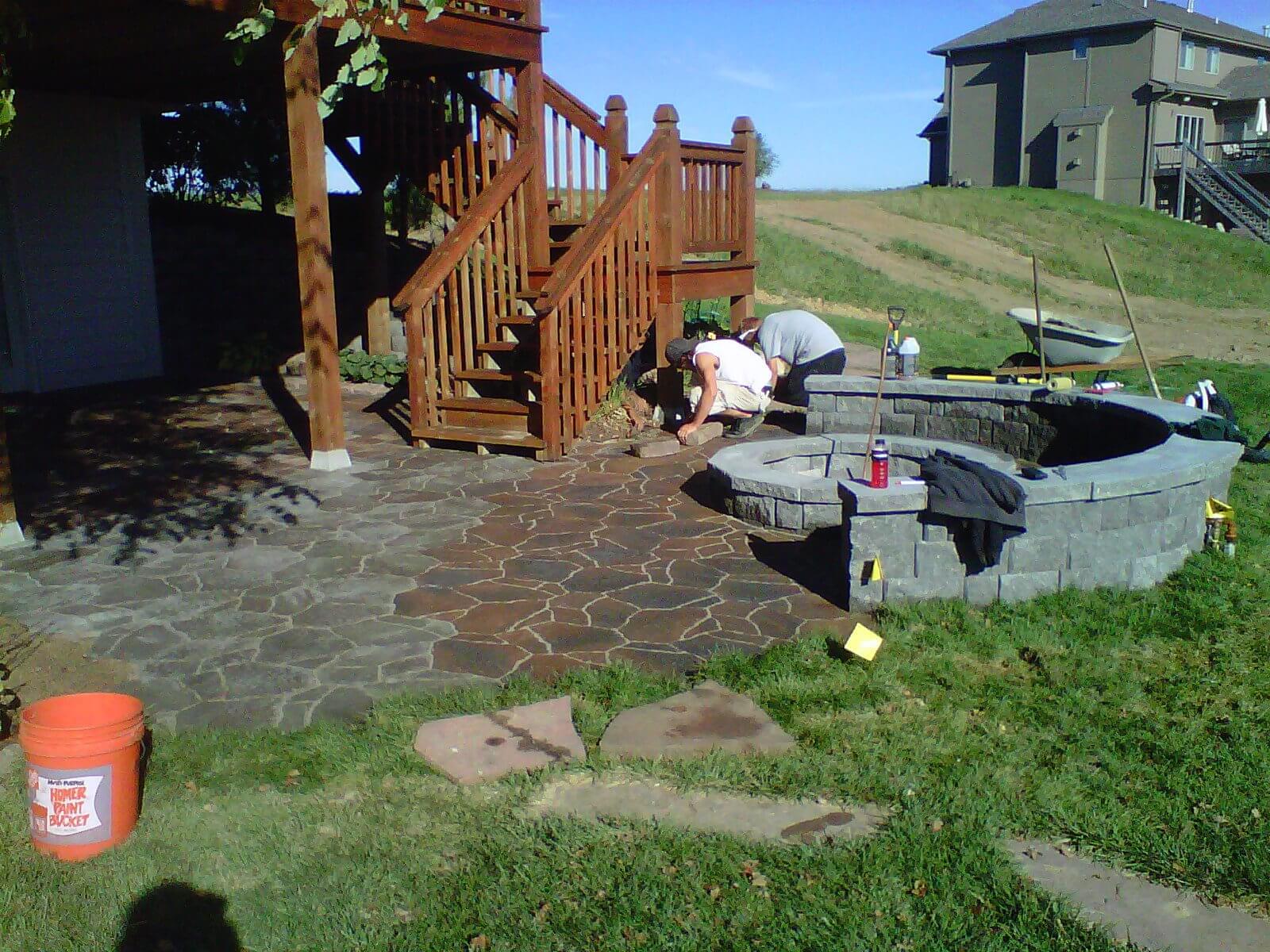 Landscaping professionals working on a custom patio in Omaha, NE.