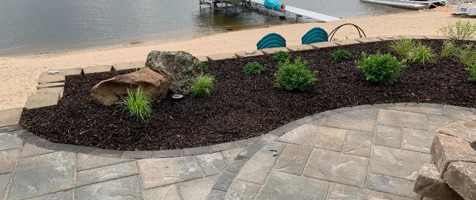 Mulch in a landscape bed near the water on a property in Omaha, NE.