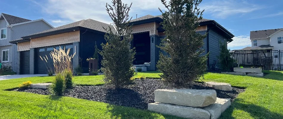 Mulched landscape with trees in a front yard in Ashland, NE.