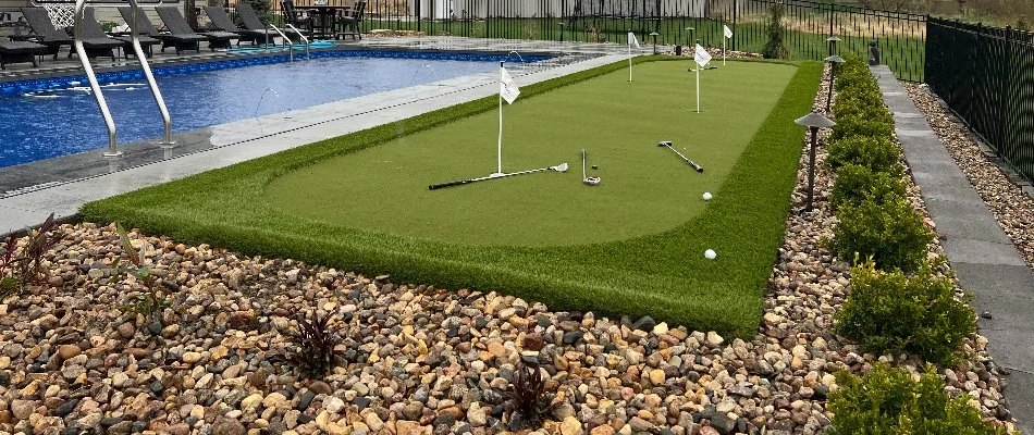 Putting green and landscaping beside a pool in Glenwood, IA.