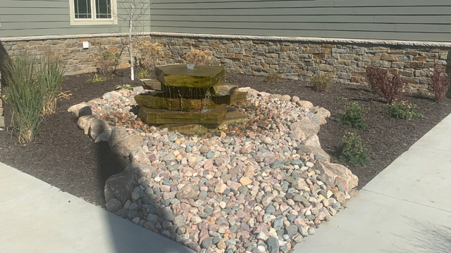 Rock installed by water feature in Millard, NE.