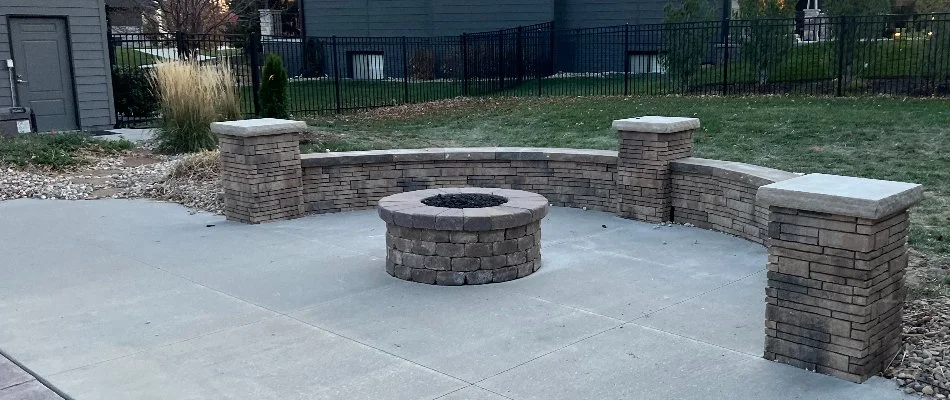 Seating wall around a round fire pit in Ashland, NE.