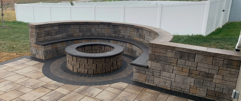 Seating wall installed over patio beside firepit in Omaha, NE.