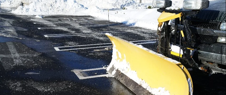 Snow plow in parking lot of a business in Omaha, NE.