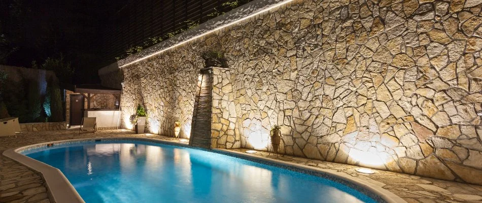 Wall-washing lighting technique near a pool in Omaha, NE.