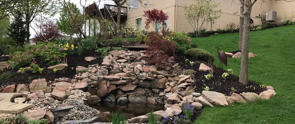 A water feature installed with landscaping added in La Vista, NE.