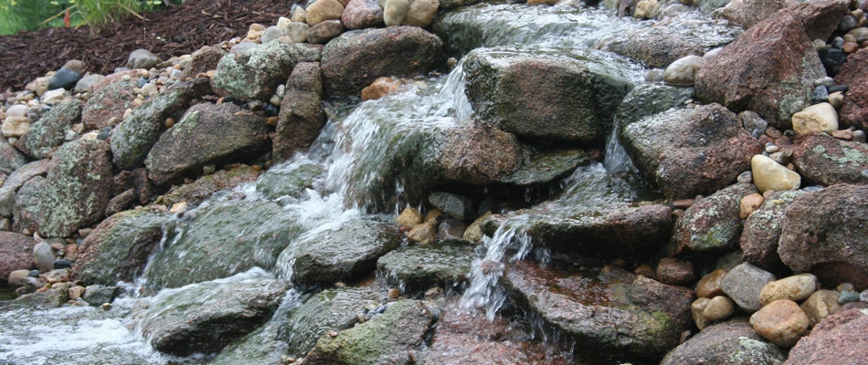 Waterfall feature installed over landscape in Valley, NE.