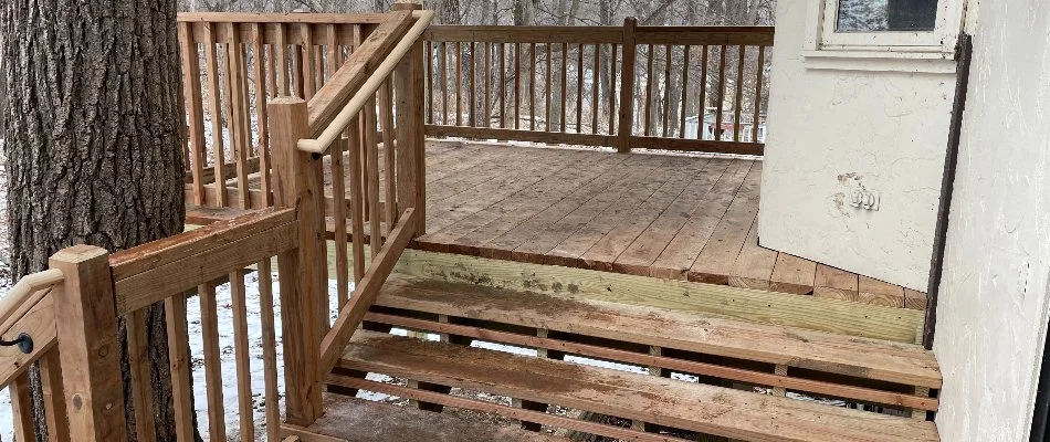 Wooden deck with stairs on a property in Omaha, NE.