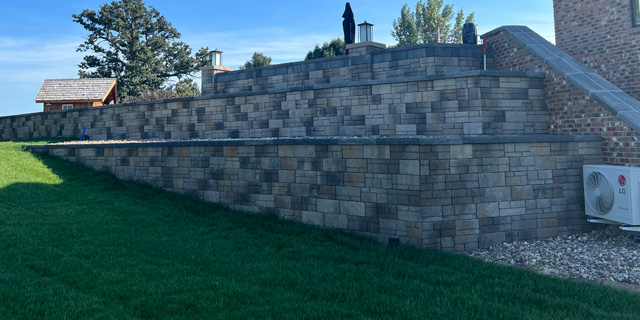 Retaining wall built off a slope from property in Omaha, NE.